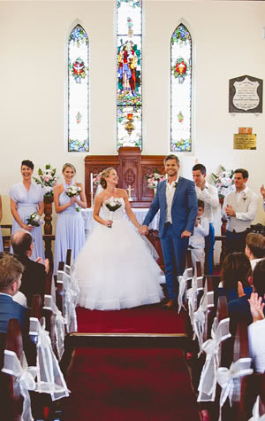 Wedding Holding Flowers at Alter